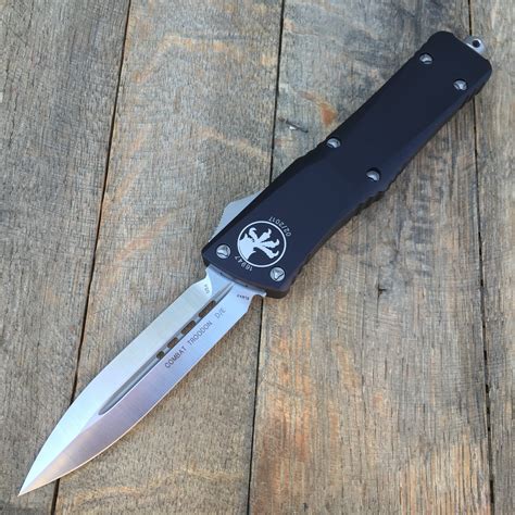 BUY Microtech: Combat Troodon - Auto OTF - Signature Series - Double Edge - Damascus STD Blade - Black Carbon Fiber Top Handle - 146-16CFS IN STOCK at . . Microtech combat troodon